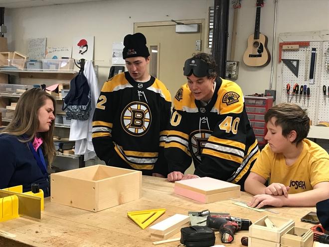 Two elite Boston Bruins players were shown up by amateur fencers at the Carroll Center for the Blind Wednesday, during the players’ visit.