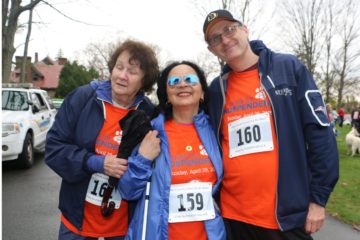 Three people standing outdoors, smiling at the Walk for INDEPENDENCE.