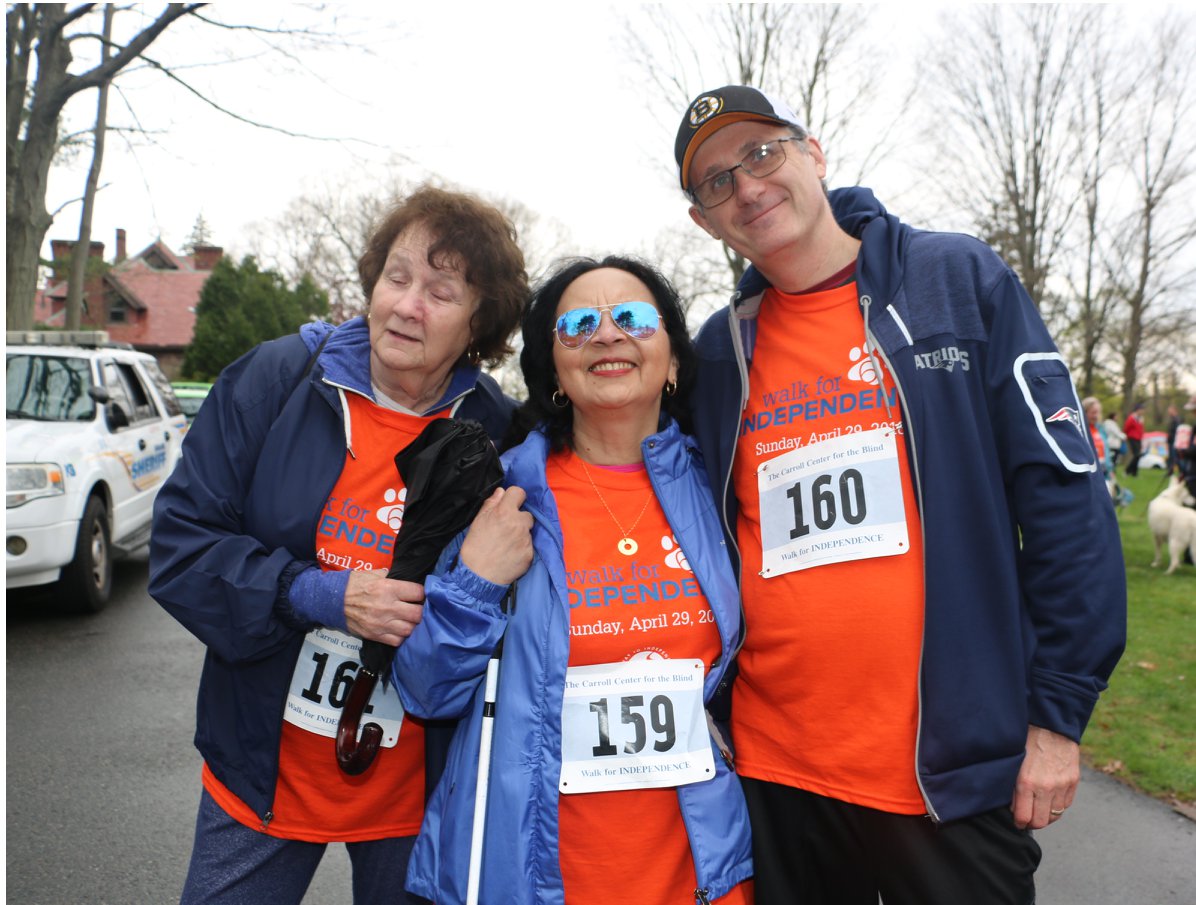 Three people standing outdoors, smiling at the Walk for INDEPENDENCE.