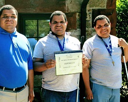Blind triplets smile together outside their dormitory after completing their Independent Living Programs.
