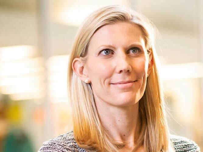 Bonnielin Swenor, an assistant professor of ophthalmology with myopic macular degeneration herself, smiles in a head shot photo.