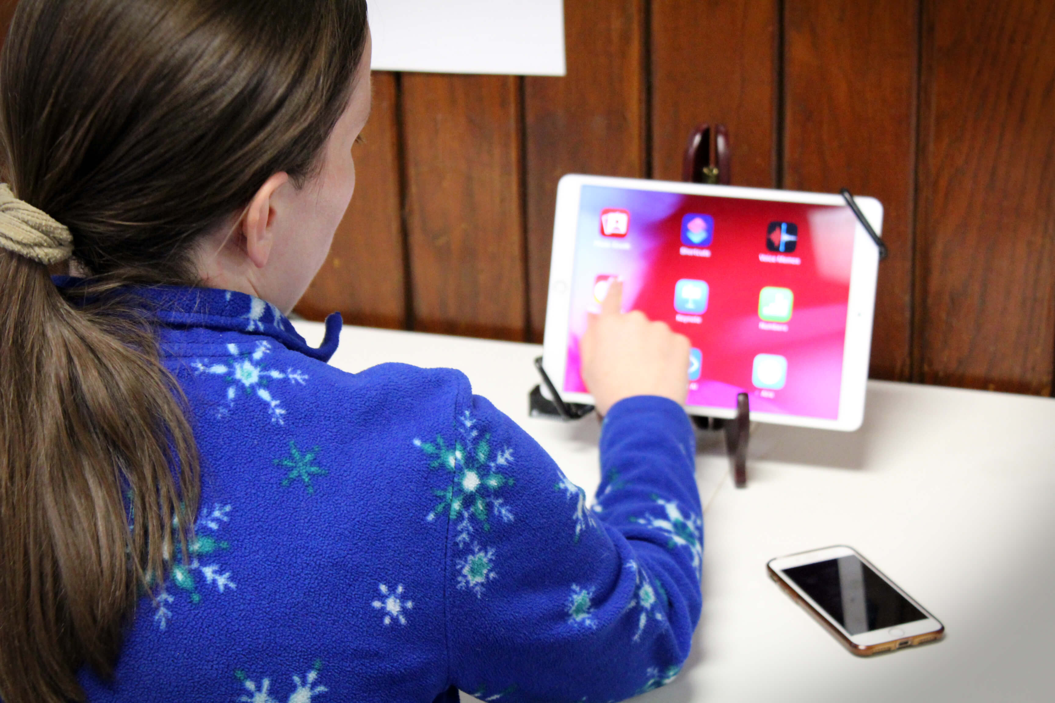 A woman explores the built-in magnifier on an iPad at the Carroll Center's assistive device lab.