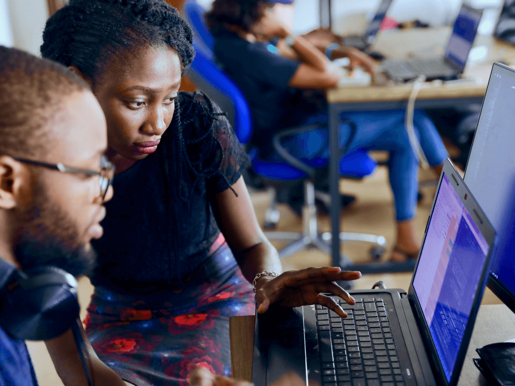 During the screen reader user tester program, an instructor teaches a participant at a computer.