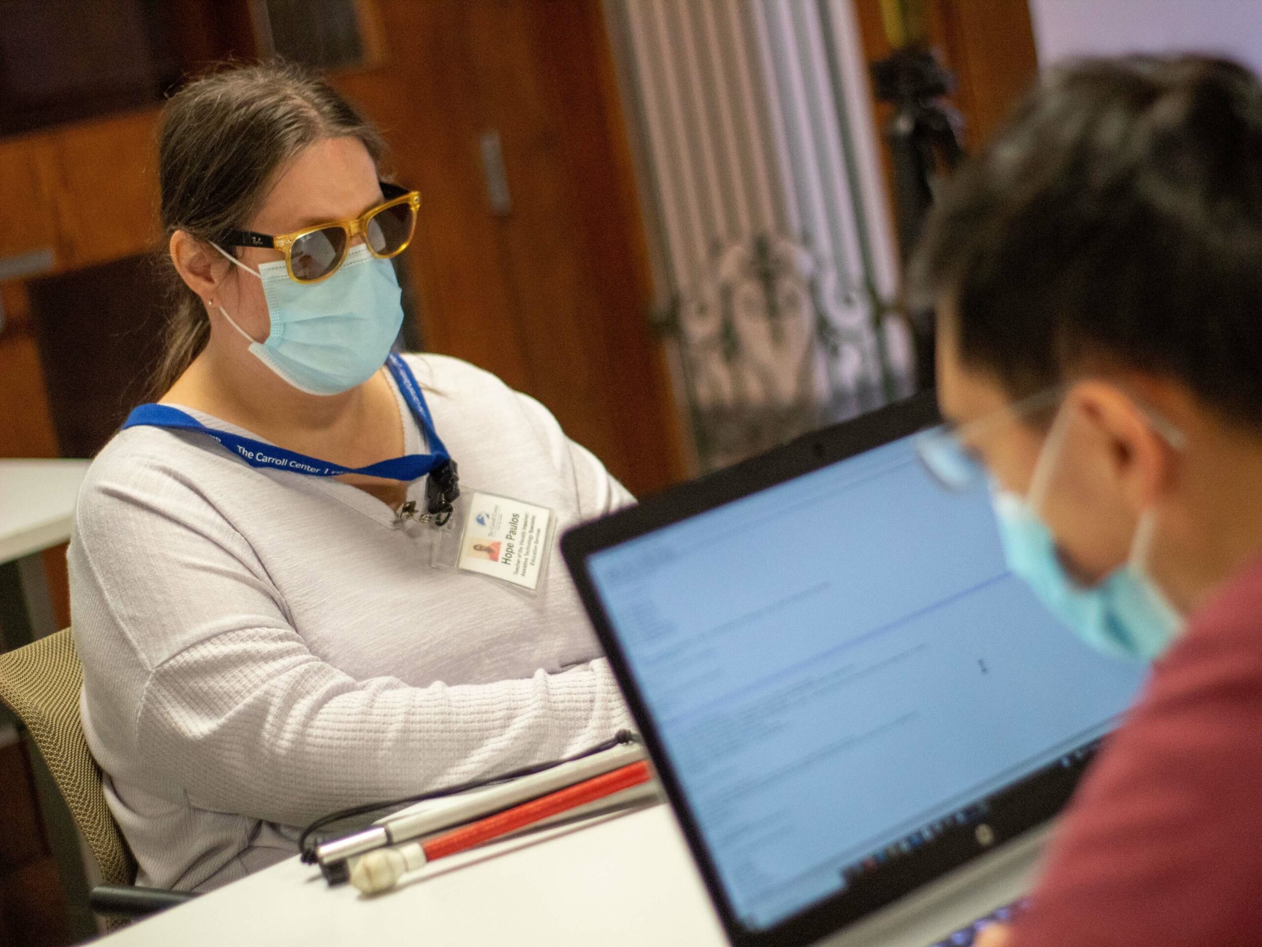 Hope Paulos, an instructor at the Carroll Center for the Blind, teaches a student how to use assistive technology.