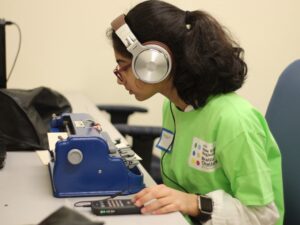 Braille Challenge participant sitting at a desk and typing on a brailler