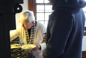 Volunteer serving lunch to a client on campus