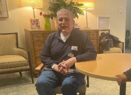 Jeff sitting and talking with a Carroll Center client at the table